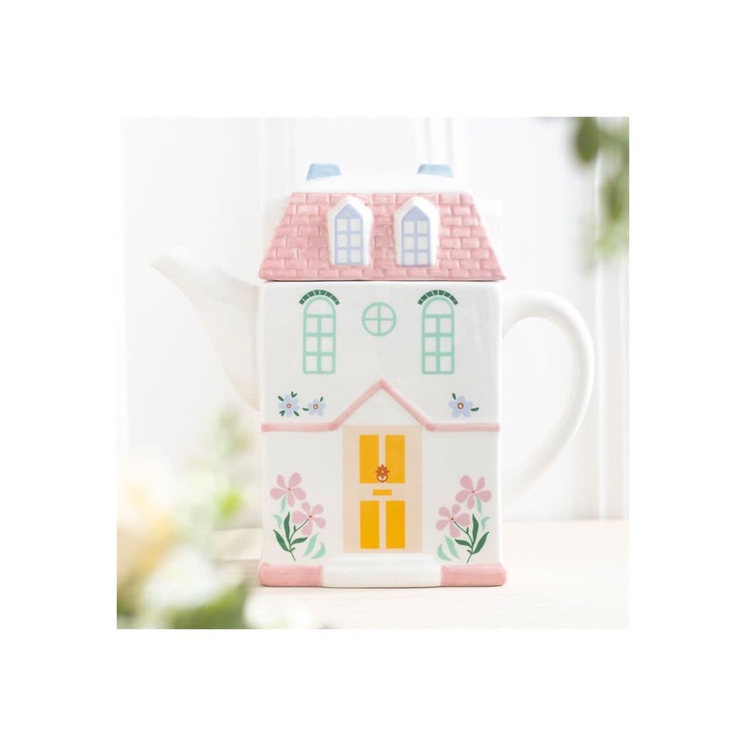Pastel house shaped teapot styled like a storybook cottage